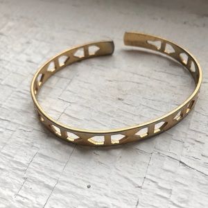 Gold bangle with geometric cutouts